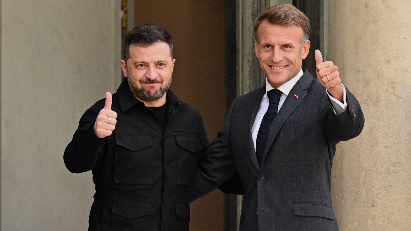 Володимир Зеленски (лево) и Емануел Макрон позирају фото-репортерима држећи палчеве на горе