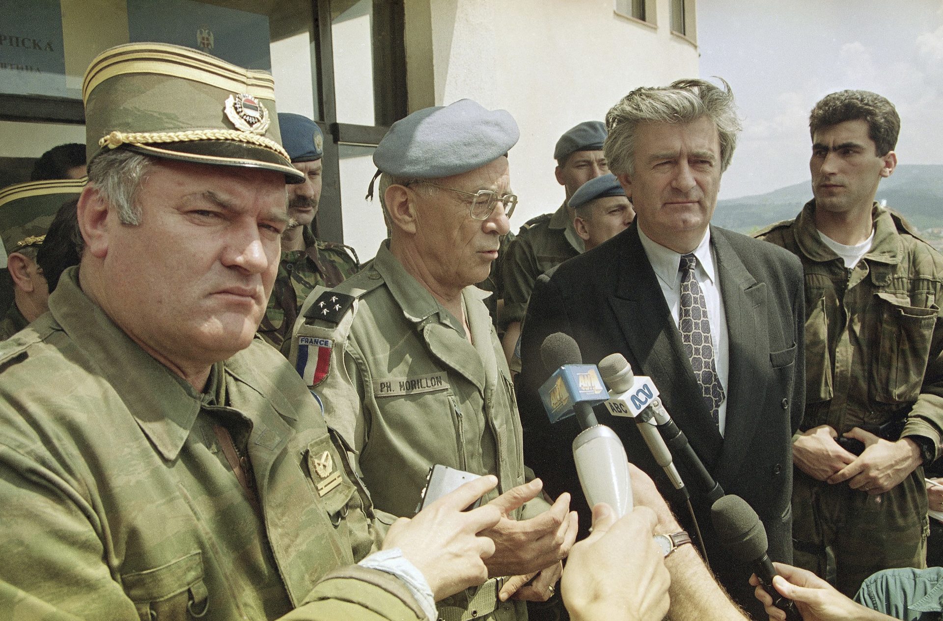 FILE - U.N. Commander General Philippe Morillon of France, flanked by Bosnian Serb General Ratko Mladic, left, and Bosnian Serb President Radovan Karadzic, right, addresses reporters in Pale, May 18, 1993, following a two and half hour meeting on the future of peace negotiations for Bosnia. (AP Photo/Jerome Delay, File)